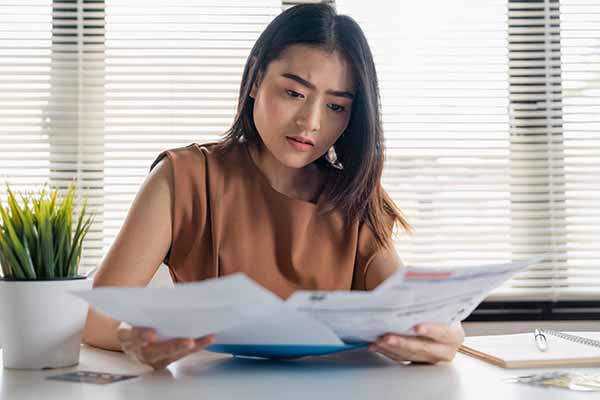 How to Lower My Electric Bill | Woman Reviewing Bill