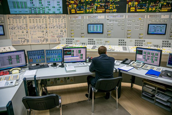 Nuclear Energy Control Room Man Sits as Console