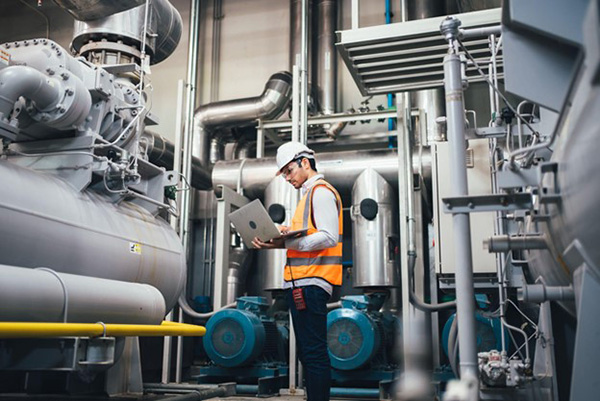 Nuclear Energy Plant Technician Taking Readings in Factory