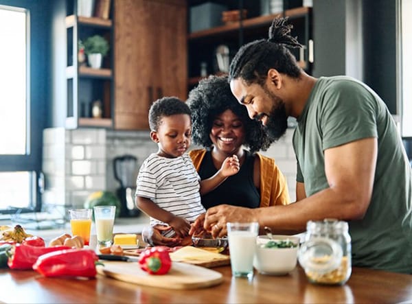 Family in Kitchen Prepares Meal